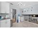 Open-concept kitchen with white cabinets, tile floors, and a view of the staircase at 2860 River Close Dr, Decatur, GA 30034
