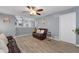 Open-concept living room with laminate floors, neutral walls, kitchen view and modern decor at 2860 River Close Dr, Decatur, GA 30034