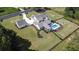 An aerial shot displays this gorgeous property and its detached garage, showcasing its expansive yard and inviting pool at 2497 Sugar Pike Rd, Canton, GA 30115
