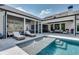 Elegant backyard featuring a pool, sun loungers, and outdoor seating with views of the home at 2497 Sugar Pike Rd, Canton, GA 30115