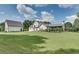 Large manicured backyard with a home and detached garage off a long concrete driveway at 2497 Sugar Pike Rd, Canton, GA 30115
