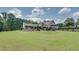 Expansive backyard featuring a well-manicured lawn and a view of the elegant modern farmhouse exterior at 2497 Sugar Pike Rd, Canton, GA 30115