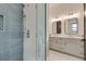 Bathroom featuring a double vanity, tiled shower, and glass shower door at 2497 Sugar Pike Rd, Canton, GA 30115