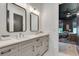 Modern bathroom featuring dual sinks, framed mirrors and white countertops with neutral colored cabinets and fixtures at 2497 Sugar Pike Rd, Canton, GA 30115