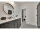 Bathroom with gray vanity, decorative tile floor, round mirror and access to toilet at 2497 Sugar Pike Rd, Canton, GA 30115