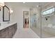 Modern bathroom featuring a glass shower, dual vanity, and access to a walk-in closet at 2497 Sugar Pike Rd, Canton, GA 30115