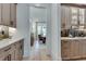 Stylish butler's pantry with light wood cabinets, quartz countertops, and sleek black hardware at 2497 Sugar Pike Rd, Canton, GA 30115