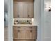 Close up of a butler's pantry with light wood cabinets, stone countertops, and decorative tile backsplash at 2497 Sugar Pike Rd, Canton, GA 30115