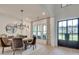 Elegant dining room featuring a round table, velvet chairs, modern chandelier, and large windows with curtains at 2497 Sugar Pike Rd, Canton, GA 30115