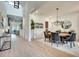 Elegant dining room features a modern chandelier, round table with six chairs, and light wood flooring at 2497 Sugar Pike Rd, Canton, GA 30115