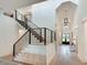 Elegant entryway showcasing a staircase with iron railings and a high ceiling with modern lighting at 2497 Sugar Pike Rd, Canton, GA 30115