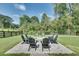 Inviting outdoor area with a stone fire pit and Adirondack chairs, perfect for gathering and relaxation at 2497 Sugar Pike Rd, Canton, GA 30115
