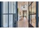 Bright foyer with high ceilings, hardwood floors, and black-framed glass doors and large windows for natural light at 2497 Sugar Pike Rd, Canton, GA 30115