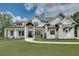 Elegant modern farmhouse with a manicured lawn, a charming walkway, and a welcoming front entrance at 2497 Sugar Pike Rd, Canton, GA 30115