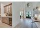 Hallway with hardwood floors leading to a bar area, featuring custom cabinets and a wine cooler at 2497 Sugar Pike Rd, Canton, GA 30115