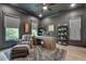 Stunning home office with a stylish desk, cozy armchair, and large windows overlooking lush greenery at 2497 Sugar Pike Rd, Canton, GA 30115