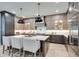 Spacious kitchen featuring two-tone cabinets, a large island with seating, and stainless steel appliances at 2497 Sugar Pike Rd, Canton, GA 30115