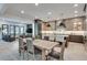 Modern kitchen with stainless steel appliances, kitchen island, and a wooden dining table at 2497 Sugar Pike Rd, Canton, GA 30115