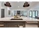 Kitchen island with marble counters and sink with views to the living area, dining room and outdoor space at 2497 Sugar Pike Rd, Canton, GA 30115