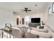 Spacious living room featuring a large sectional, ceiling fan, and plenty of natural light at 2497 Sugar Pike Rd, Canton, GA 30115