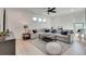 Cozy living room with large sectional sofa, ceiling fan, and natural light at 2497 Sugar Pike Rd, Canton, GA 30115