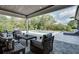 Inviting covered patio featuring stylish seating with a view of the pool and surrounding landscaping at 2497 Sugar Pike Rd, Canton, GA 30115