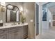 Elegant powder room featuring a gray vanity, quartz countertop, and decorative mirror and lighting at 2497 Sugar Pike Rd, Canton, GA 30115