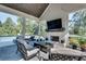 Inviting screened porch with a fireplace, a TV, a seating area, a dining area, and a view of the pool at 2497 Sugar Pike Rd, Canton, GA 30115