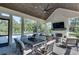 Beautiful screened porch with vaulted wood ceiling, ceiling fan, fireplace and outdoor lounge and dining furniture at 2497 Sugar Pike Rd, Canton, GA 30115