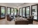 Inviting sitting area with leather chairs, multiple glass doors, light hardwood flooring, and lots of natural light at 2497 Sugar Pike Rd, Canton, GA 30115