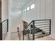 Bright staircase featuring a modern railing and views of the living area below at 2497 Sugar Pike Rd, Canton, GA 30115