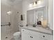 Elegant bathroom showcasing a quartz countertop, a walk-in shower, and vanity lighting at 336 Little Pine Ln, Woodstock, GA 30188