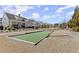 Community bocce ball court surrounded by lush greenery, and walking path at 336 Little Pine Ln, Woodstock, GA 30188