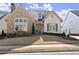 Charming home featuring stone accents, a well-manicured lawn, and a welcoming front door at 336 Little Pine Ln, Woodstock, GA 30188