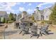 Outdoor stone fireplace surrounded by comfortable seating, creating a cozy gathering spot at 336 Little Pine Ln, Woodstock, GA 30188