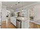 Modern kitchen with a large island, stainless steel appliances, and hardwood flooring at 336 Little Pine Ln, Woodstock, GA 30188