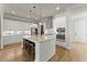 Modern kitchen featuring stainless steel appliances, granite countertops, and a central island with seating at 336 Little Pine Ln, Woodstock, GA 30188