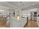 Open-concept kitchen with stainless appliances and a central island flows into the dining area at 336 Little Pine Ln, Woodstock, GA 30188