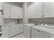 Bright laundry room with sink, storage and modern appliances at 336 Little Pine Ln, Woodstock, GA 30188