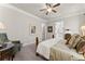 Well-lit main bedroom featuring decorative windows, hardwood floors, and a ceiling fan at 336 Little Pine Ln, Woodstock, GA 30188