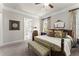 Well-lit main bedroom featuring decorative windows, hardwood floors, and a ceiling fan at 336 Little Pine Ln, Woodstock, GA 30188