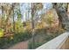 Wooded backyard featuring mature trees providing privacy and a scenic view from the deck at 3451 Keswick Ct, Atlanta, GA 30341