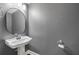 Bathroom with pedestal sink, mirror and grey painted walls at 3451 Keswick Ct, Atlanta, GA 30341