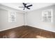 Bedroom with two windows, a ceiling fan and dark wood floors at 3451 Keswick Ct, Atlanta, GA 30341