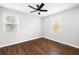 Bedroom with two windows, ceiling fan and dark wood floors at 3451 Keswick Ct, Atlanta, GA 30341