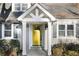 Close up of a home's inviting entrance with a bright yellow door and stylish architectural features at 3451 Keswick Ct, Atlanta, GA 30341