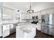 Well-lit kitchen with stainless appliances, granite counters and dark wood floors at 3451 Keswick Ct, Atlanta, GA 30341