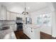 Modern, bright kitchen with stainless steel appliances, white cabinets, and an island with granite countertops at 3451 Keswick Ct, Atlanta, GA 30341