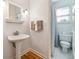 Cozy bathroom with pedestal sink, tiled floor, and combined shower and tub at 3999 Treemont Ln, Suwanee, GA 30024