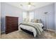 Comfortable bedroom featuring an overhead fan, natural light, and carpeted floors at 3999 Treemont Ln, Suwanee, GA 30024